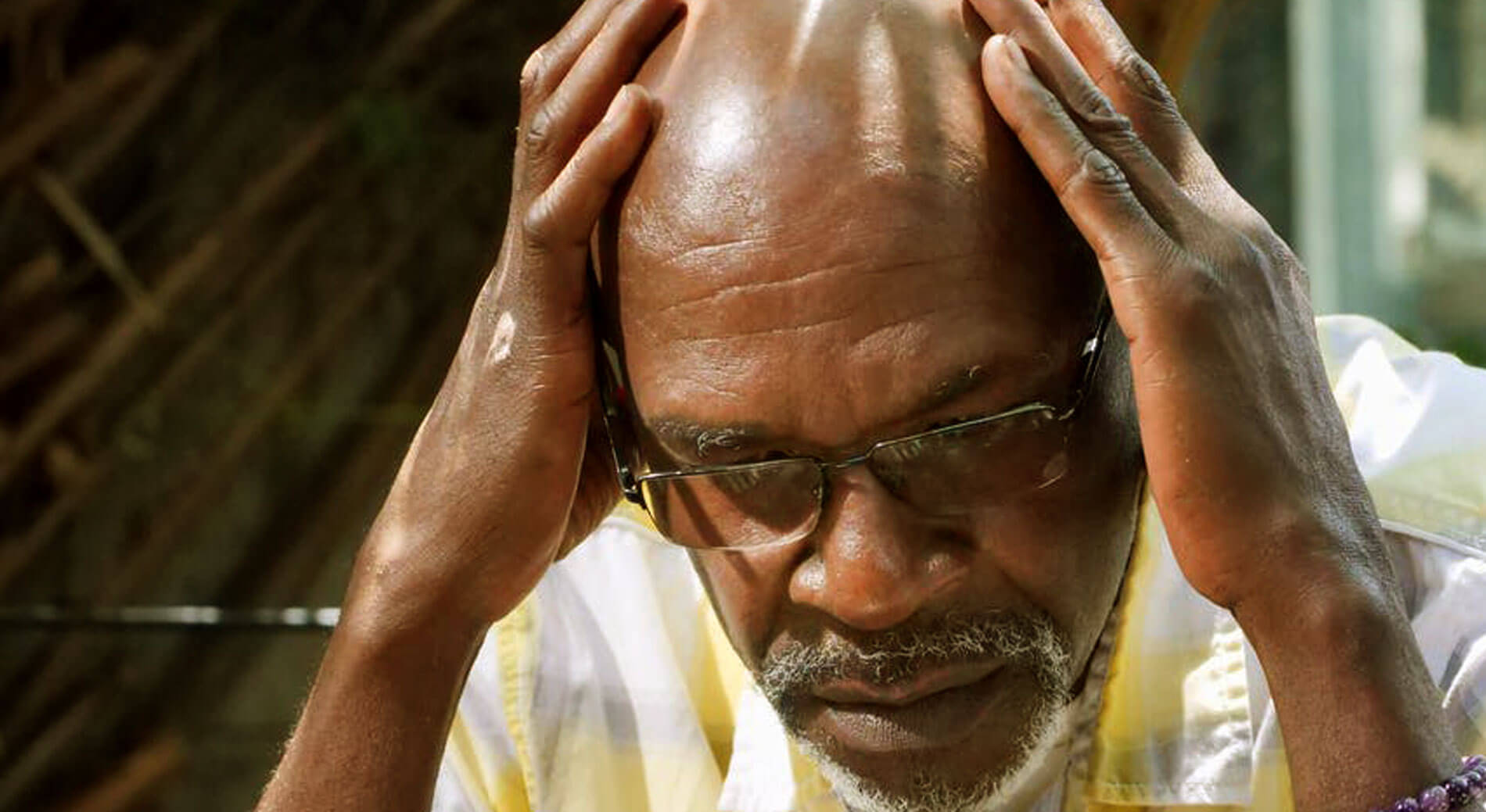 Picture of man holding head.