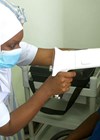 Photo showing Shamin Haroun using the Optomed fundus camera for diabetic screening in Dodoma.