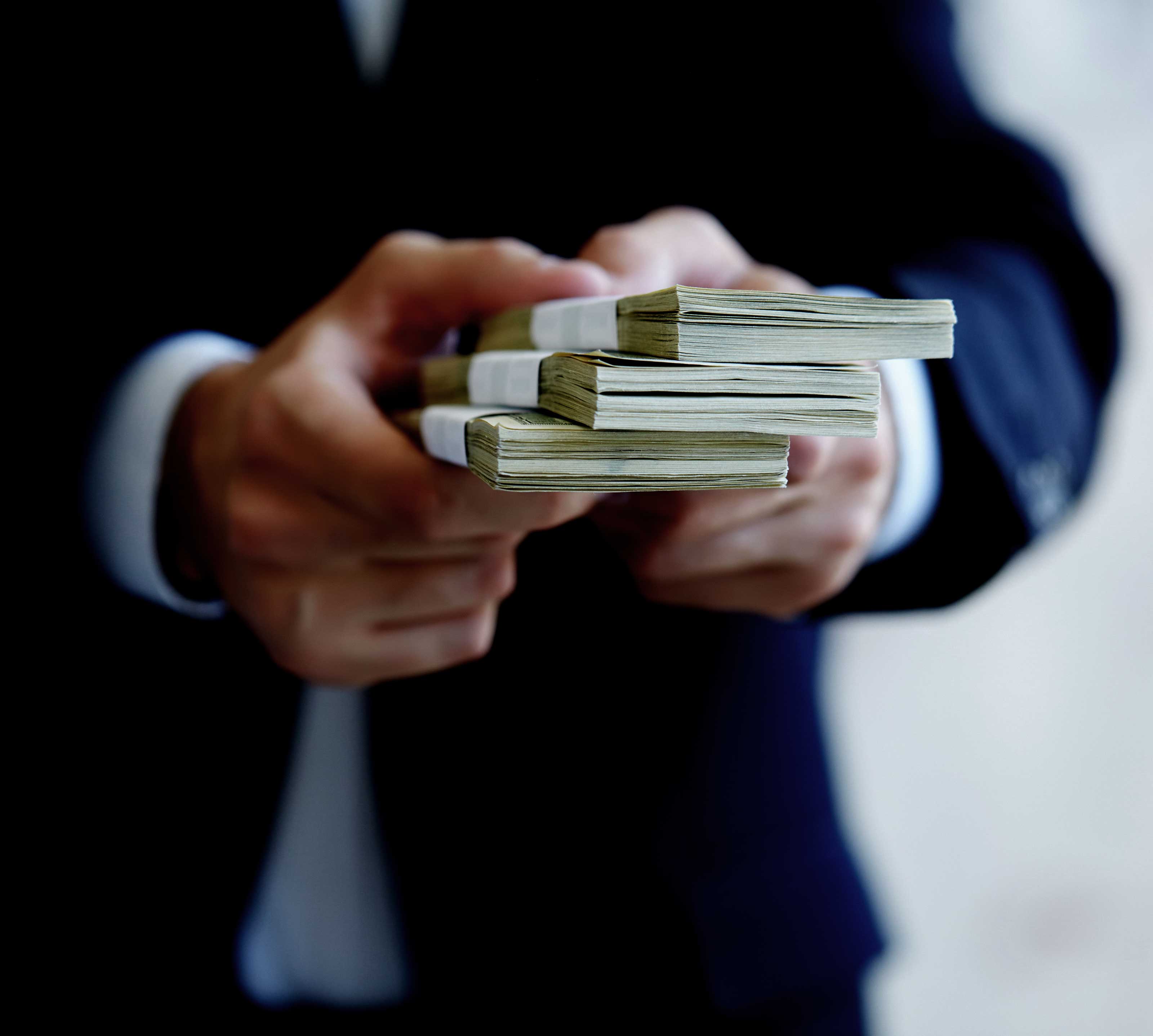 Image of person holding money.